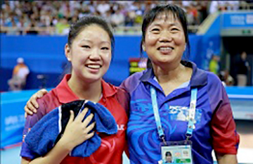On left, Lily Zhang, winner of a Bronze Medal in the 2014 Summer Youth Olympics, and her coach, Lily Yip, proprietor of Lily Yip Table Tennis Center.