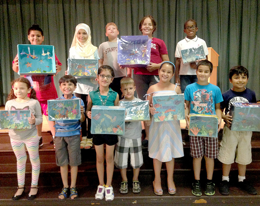 (above) To enhance her students' awareness, understanding and appreciation for life in the marine environment, ESL teacher Mrs. Danie Orelien-Armstead had them build an aquarium. Students attending the ESL Summer Enrichment Program for the month of July at School# 9 had fun exploring and discovering how their lives are connected to the ocean. Students studied the natural habitat of ocean animals, the needs of living organisms in an aquatic environment, their dependency on each other for survival and the impact of human activities on marine life environment. At the end of the program, students designed and build their own aquarium. According to ESL teacher, Mrs. Danie Orelien Armstead, "Building their own aquarium allowed students to discover that other living organisms have basic needs just like human beings do. People have a responsibility to protect and keep the oceans healthy. 
