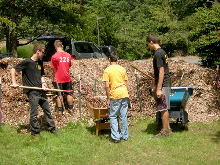 Working on the pile of woodchips, (above l-r): Rob Pilsbury, Andrew Cantone, Jaison Desai, Mitchell DiPaolo