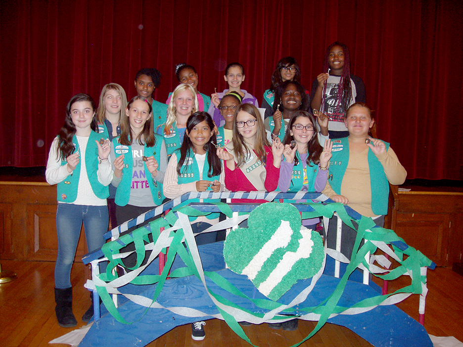 (above) Troop 65255 members bridge to cadets, receive their certificates for community service and 10 of 17 receive Bronze Award Pins; shown first two rows (l-r): Nicole Lindemeyer, Brianna Cookman, Emma Collazo, Kendy Coxwell Rudy, Julia Gomes, Madison Kasper, Kerry Pierro, Carly Robertson, Niah Llewellyn and Kaila Barnes. Troop members shown last two rows (l-r): Zuri Felton, Amani Weeks, Victoria Smagalla, Alicia Dey and Naila Twyman. Not shown: Dominique Geiger and Sydney Waddy.