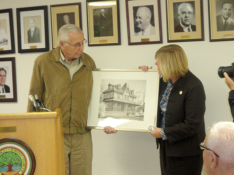 (above) Volunteer-of-the-month Joe Nagy, left, thanks the Fanwood Council after he was honored as the borough’s volunteer-of-the-month at the council meeting. Mayor Colleen Mahr, right, holds the framed print of the borough’s historic north side train station, which was presented to Nagy.