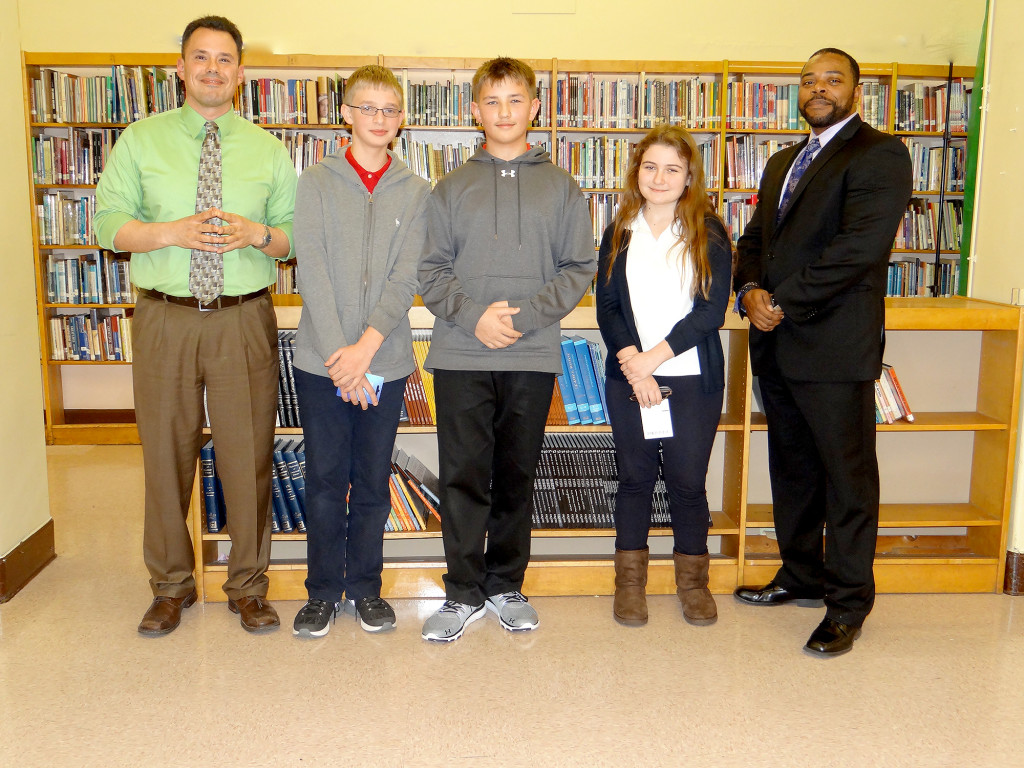 (above) McManus Social Studies teacher Anthony Ventura, top three finalists Alexander Stapkowitz, Thomas Turon and Anna Pieta and Principal Kcyronne Zahir. Mr. Zahir commends these students on their academic achievements.