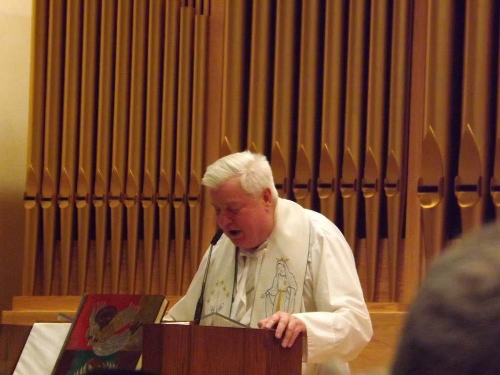 (above) Father Richard J. Carrington, OLL’s pastor, leads the congregation in the novena to Our Lady of Lourdes.