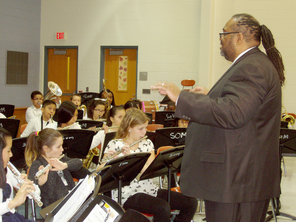 (above) Lucas Miller, director of the Somerset Singers and Chorus introduces the next number at the Somerset School Band, Singers, Chorus Concert.