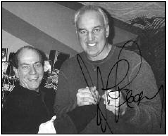 (above, l-r) An autographed photo of Joe Aprile with his long-time customer, prize fighter Gerry Cooney adorns the wall of his barber shop, Mr. J’s, in Westfield.