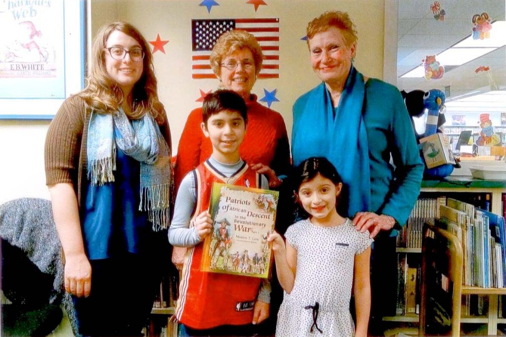 (above) Children’s Librarian Lauren Antolino was presented the book “Patriots of African Descent in the Revolutionary War,” donated for Black History Month by the Cranford DAR. Chapter members Mary Leonard (center) and Barbara Krause (right) made the presentation with Kiran Davis, 4th grade, and Sienna Griffin, 2nd grade, students at Brookside Place School, the first to receive it.