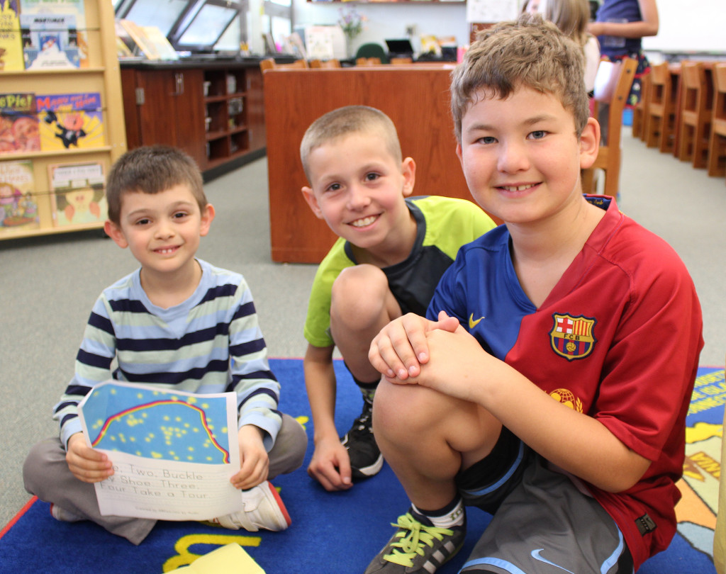 (above) Kindergartner Aydin Cakirdas (L) shares his poem with fourth grade “buddies” Robert Battiste (middle) and Alexander Skiadas ® on National Poem in Your Pocket Day.