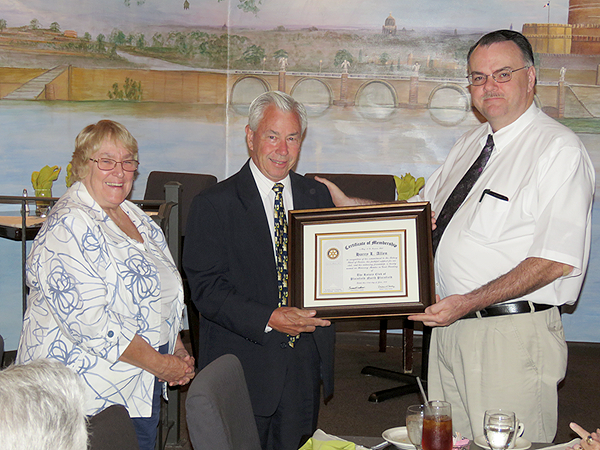 (above r-l) Rotary President-Elect Michael Castoral presents a “Certificate of Membership” to new honorary member Harry Allen, accompanied by his wife, Janice.